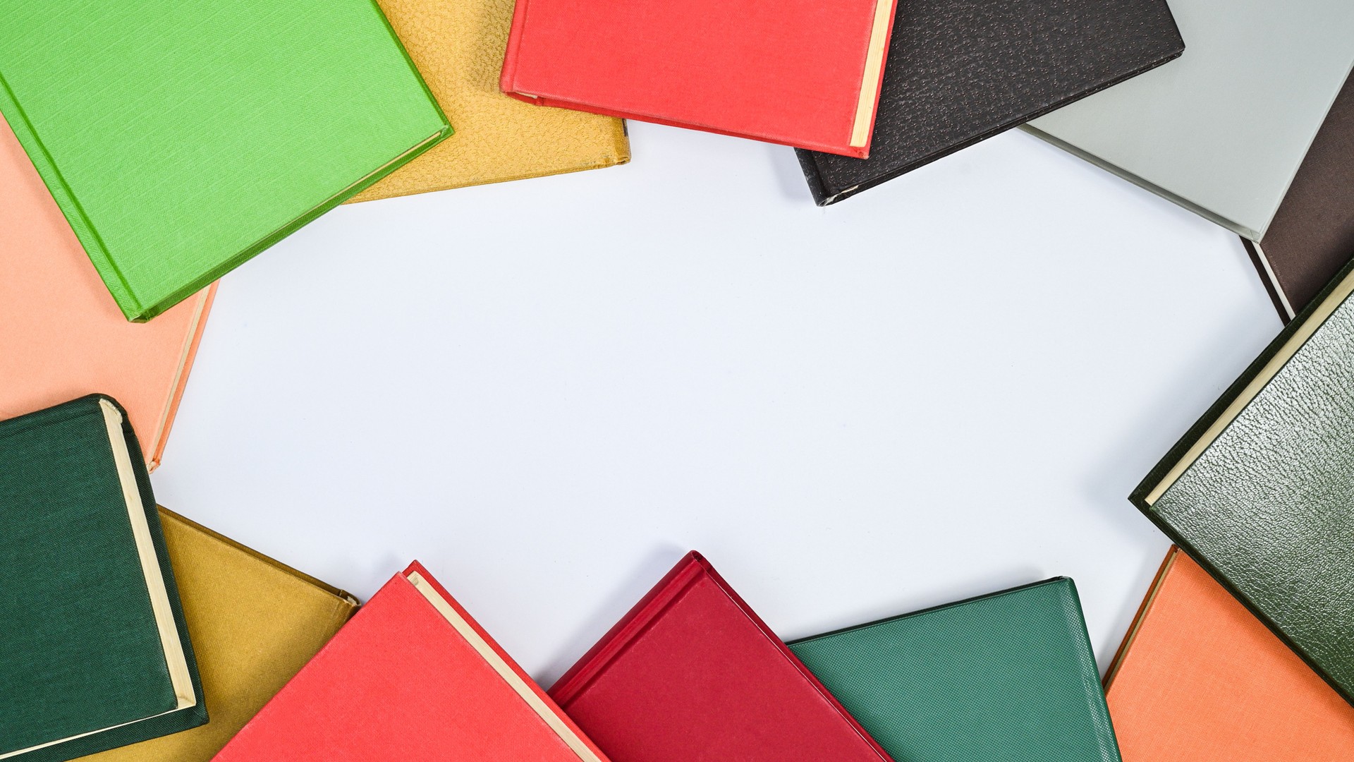 Creative copy space frame on white background with hardcover vintage books. Flat lay